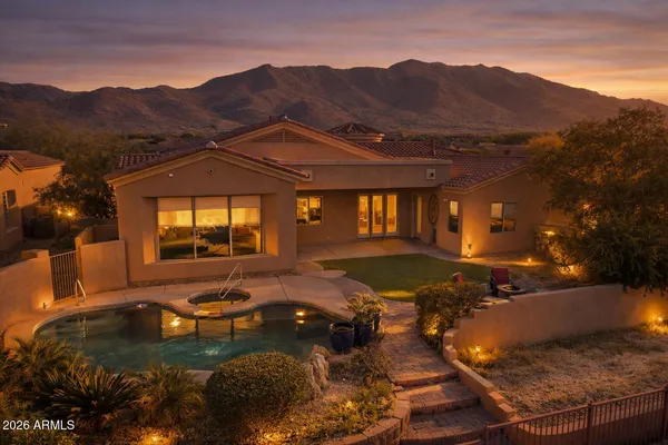 a view of a house with pool and a yard