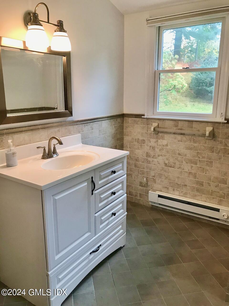 7 River Lane Cos Cob, CT 06807 - Photo 12 of 30 a bathroom with a sink a vanity and a mirror