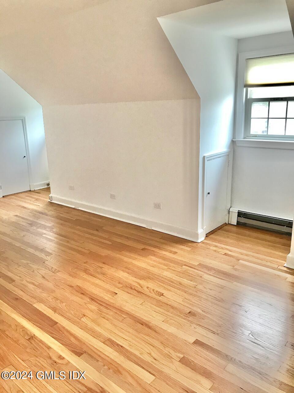 7 River Lane Cos Cob, CT 06807 - Photo 15 of 30 an empty room with wooden floor and windows