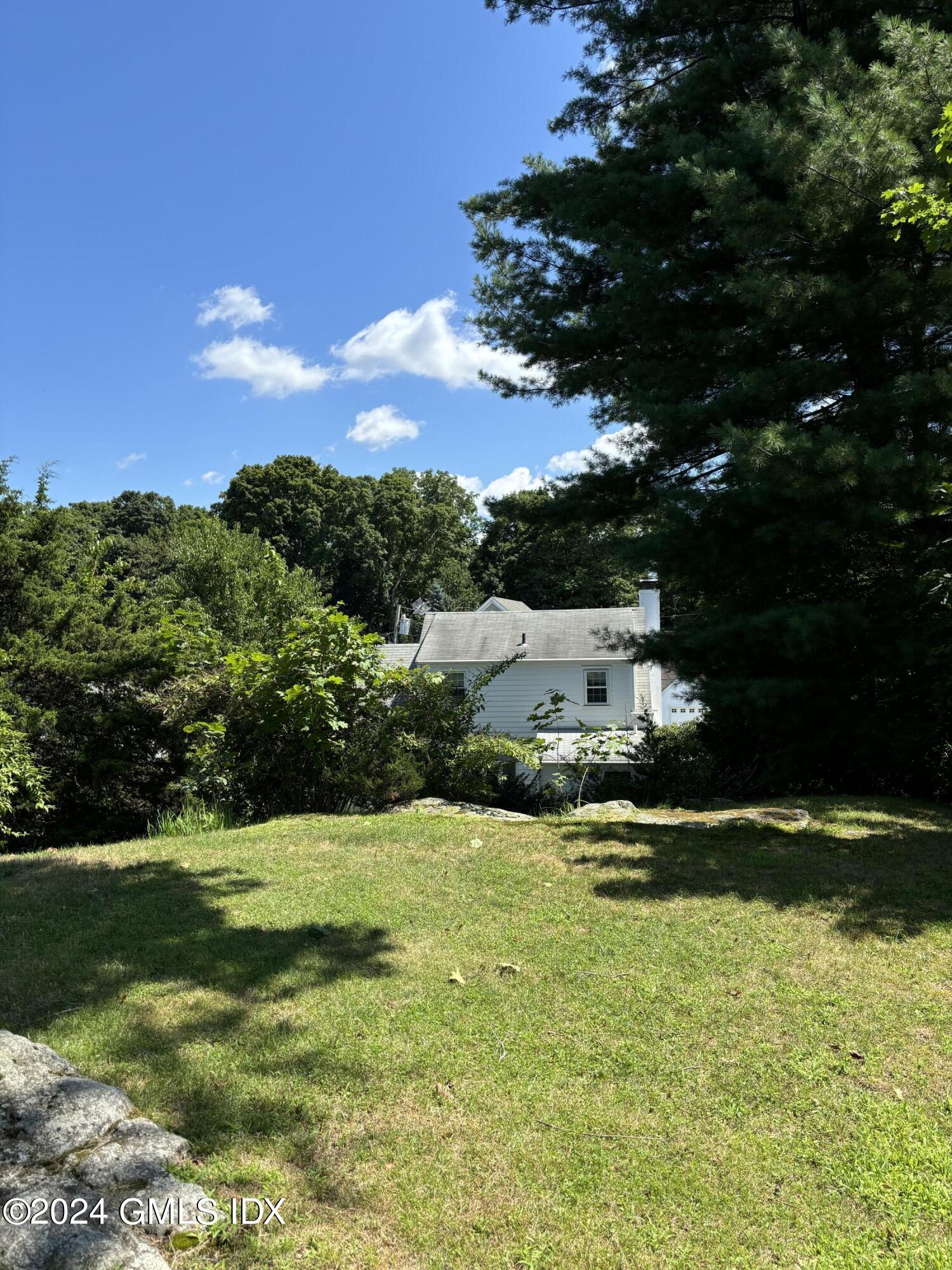 7 River Lane Cos Cob, CT 06807 - Photo 24 of 30 a view of a house with a yard