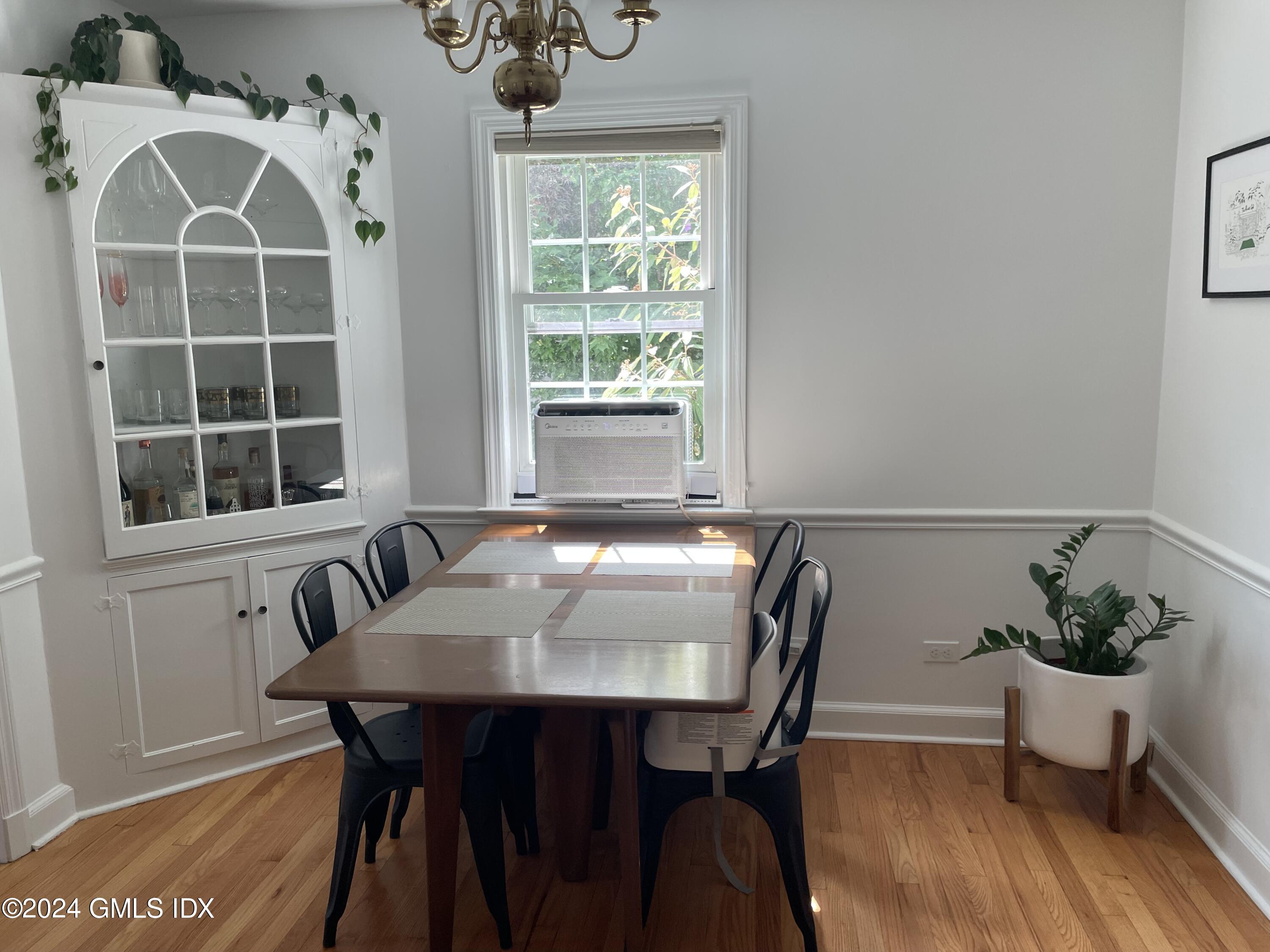 7 River Lane Cos Cob, CT 06807 - Photo 8 of 30 a view of a dining room with furniture window and wooden floor