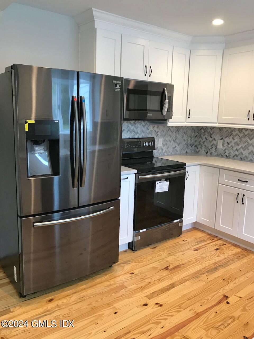 7 River Lane Cos Cob, CT 06807 - Photo 10 of 30 a kitchen with stainless steel appliances granite countertop a refrigerator and a stove top oven