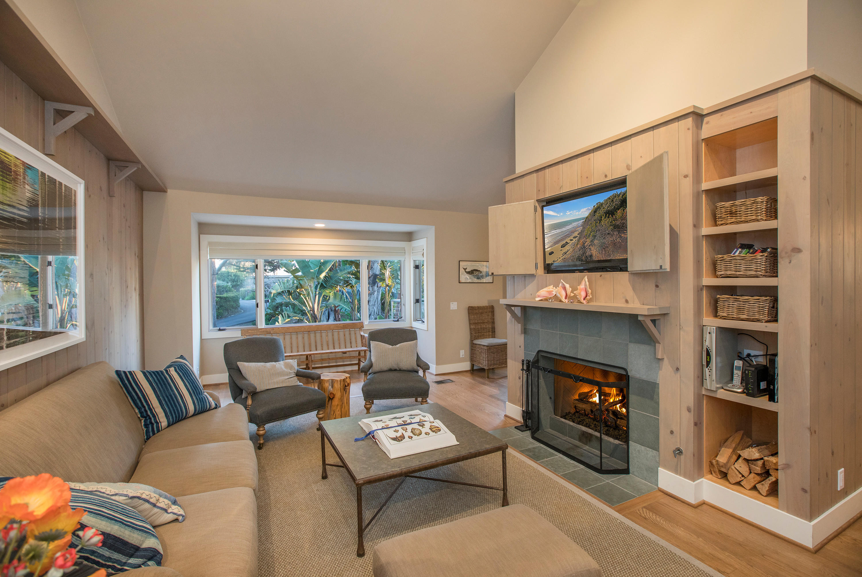 2 Rincon Point Lane Carpinteria, CA 93013 - Photo 7 of 31 a living room with furniture a flat screen tv and a fireplace