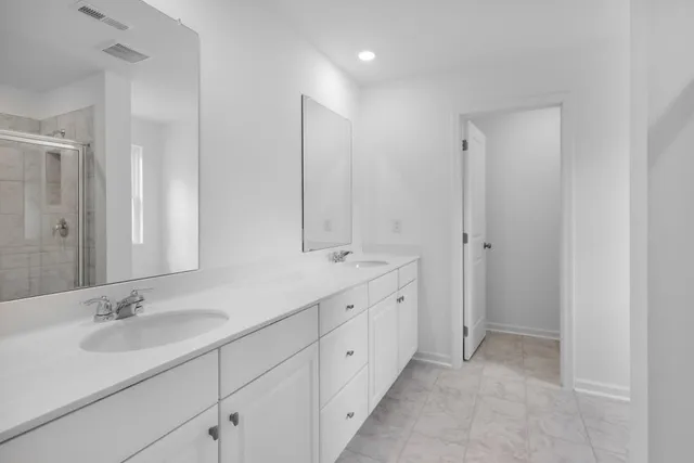 a bathroom with double sink and a mirror