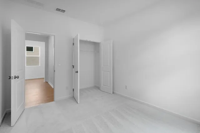 an empty room with closet area