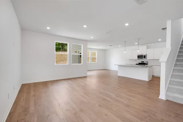 a view of kitchen with cabinets and wooden floor