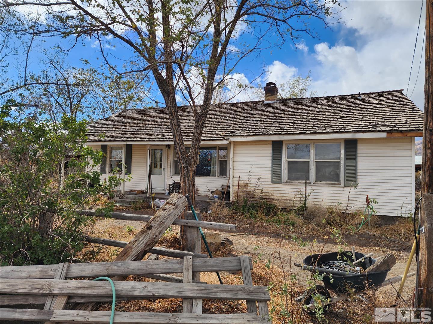 a front view of a house with sitting area