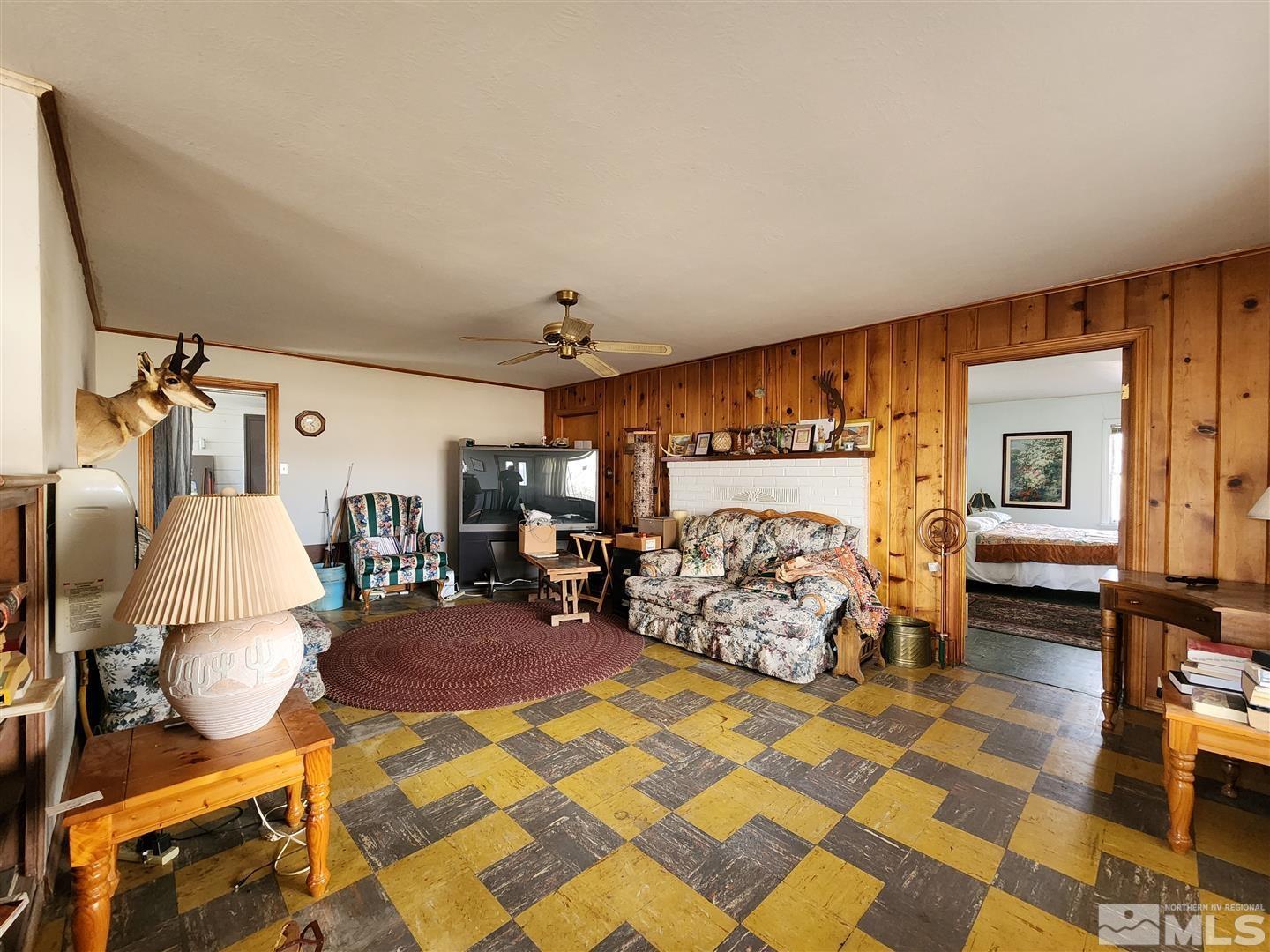 35 Highway 208 Yerington, NV 89447 - Photo 2 of 16 a bed room with a bed and chair