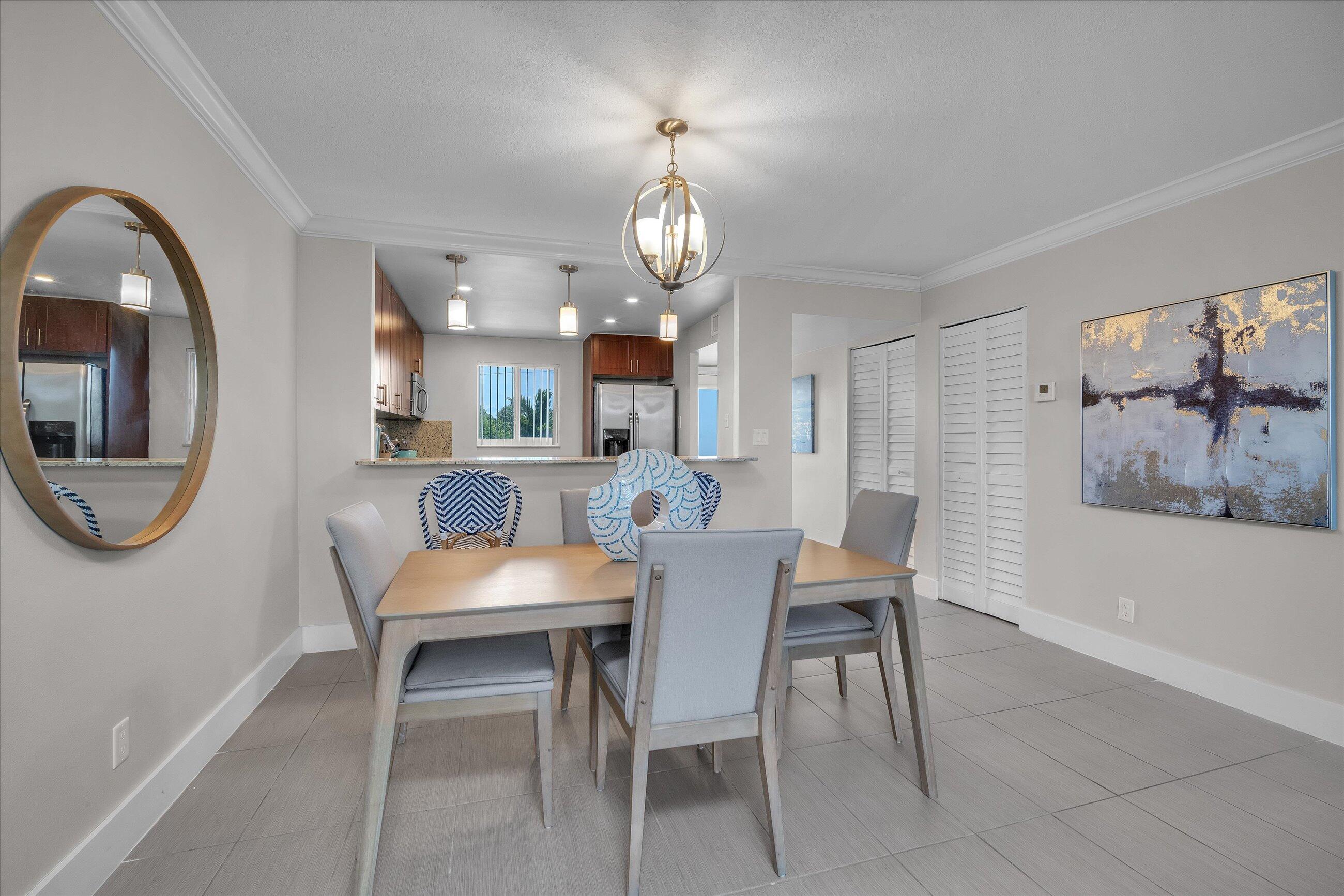 601 North Ocean Boulevard, Unit 203 Boca Raton, FL 33432 - Photo 13 of 20 a view of a dining room with furniture and a chandelier