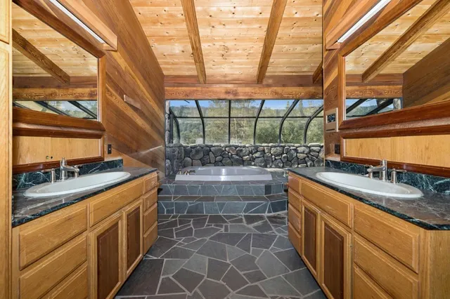 a kitchen with stainless steel appliances granite countertop a sink and a stove
