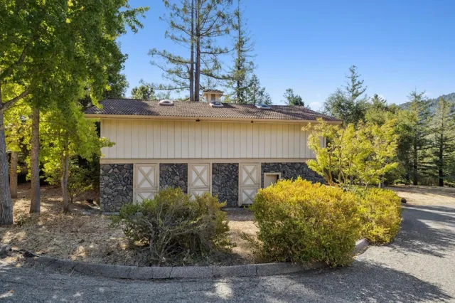 a view of a house with a yard and tree s