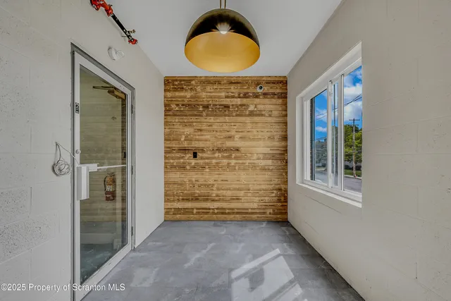 an entryway view with wooden floor and windows