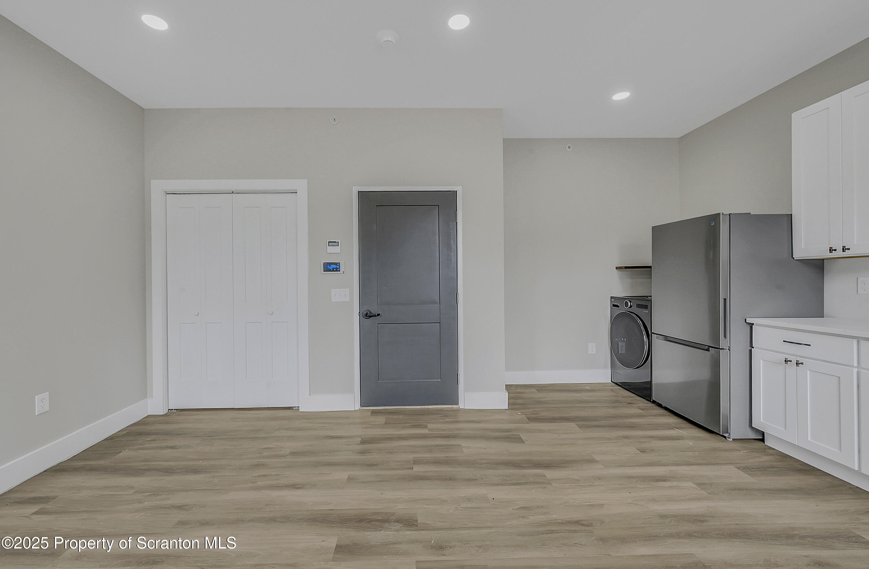 215 Hickory Street, Unit 8 Scranton, PA 18505 - Photo 7 of 18 a view of a kitchen with a refrigerator cabinets and wooden floor