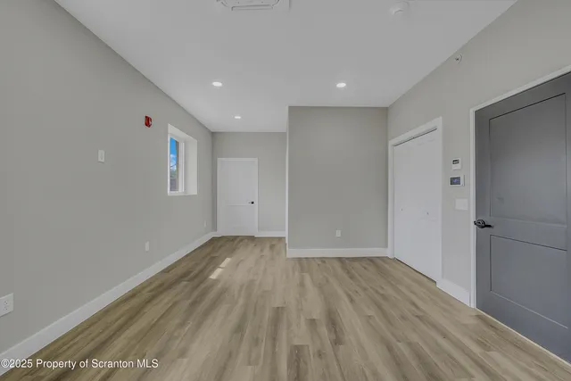 a view of wooden floor and windows in a room