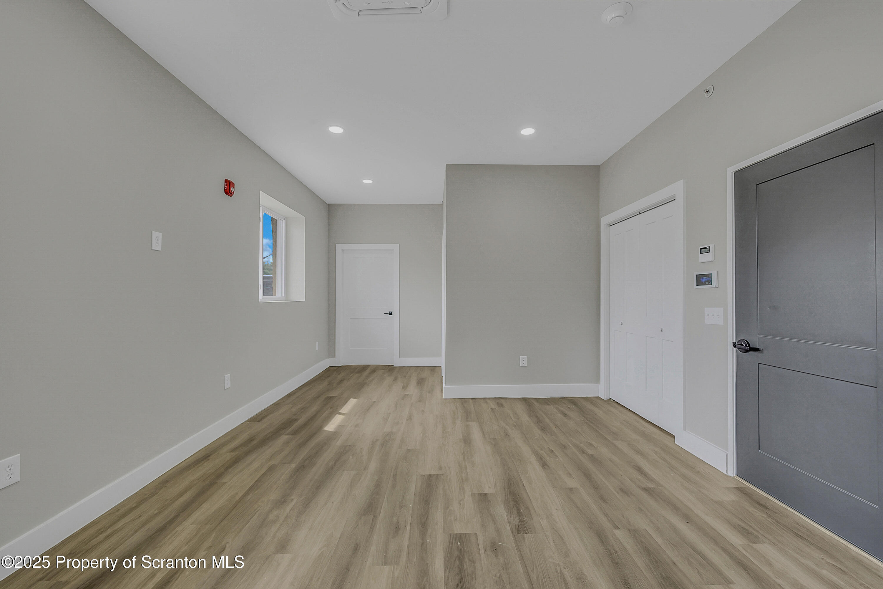 215 Hickory Street, Unit 8 Scranton, PA 18505 - Photo 8 of 18 a view of wooden floor and windows in a room