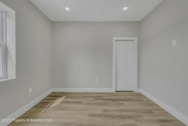 a view of a room with wooden floor