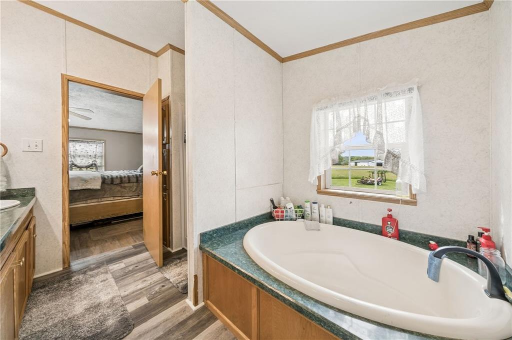 275 Adamik Road Clarksville, PA 15322 - Photo 10 of 39 a en suite bathroom with a granite countertop tub and a sink