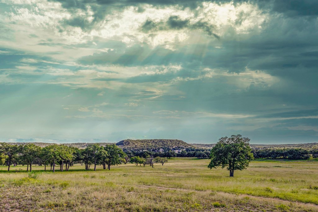 451 Achtzehn Road Fredericksburg, TX 78624 - Photo 6 of 11 a view of a lake with houses in the back