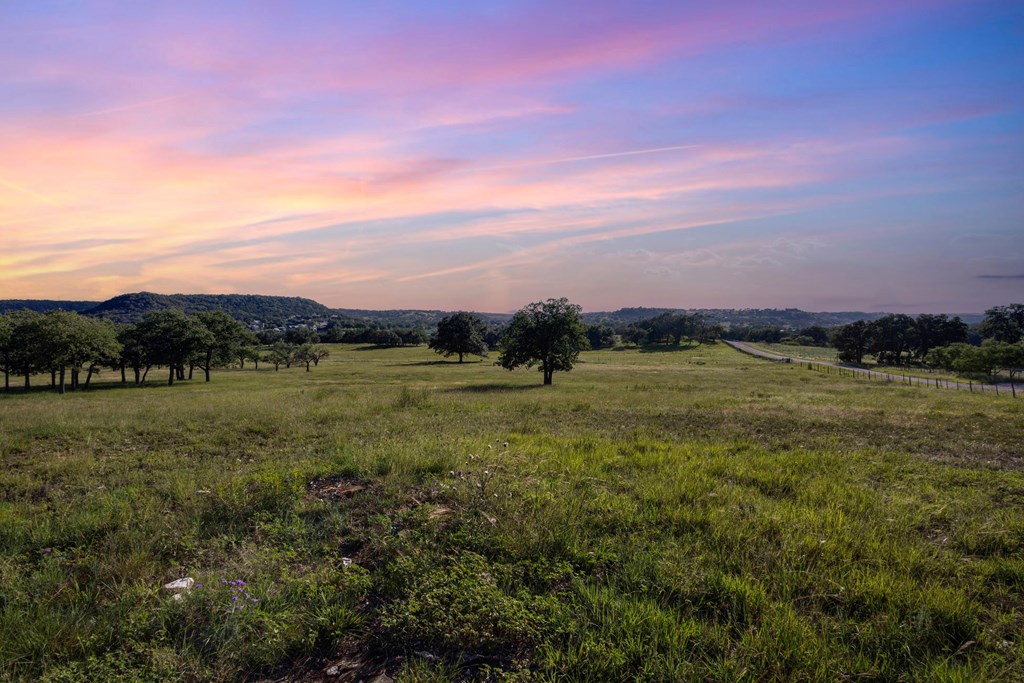 451 Achtzehn Road Fredericksburg, TX 78624 - Photo 10 of 11 a view of a lake in front of sunset
