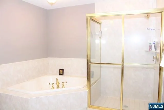 a bathroom with a tub and a sink