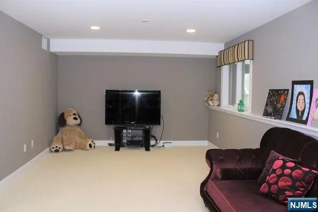 a living room with furniture and a book shelf