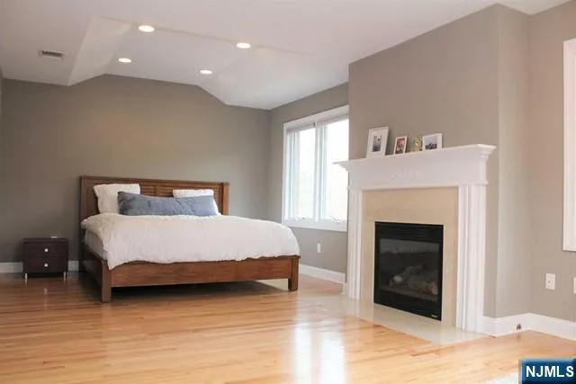 a bedroom with a bed and a fireplace