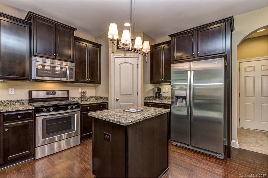 3032 Fallondale Road Waxhaw, NC 28173 - Photo 12 of 23 a kitchen with stainless steel appliances granite countertop a refrigerator a stove a sink and a refrigerator