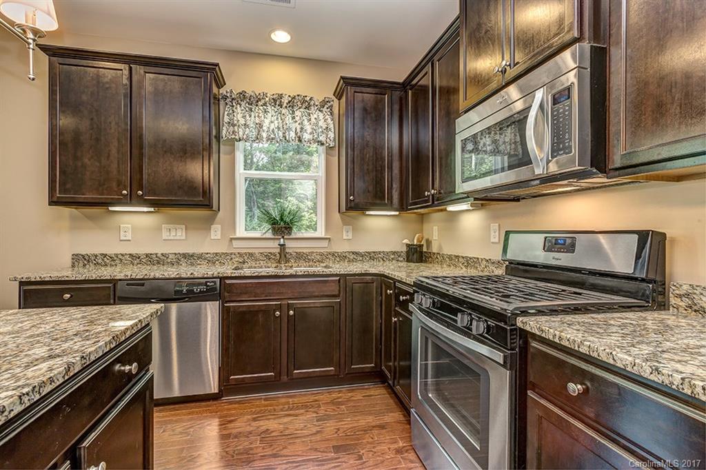 3032 Fallondale Road Waxhaw, NC 28173 - Photo 13 of 23 a kitchen with stainless steel appliances granite countertop a stove a sink and a microwave