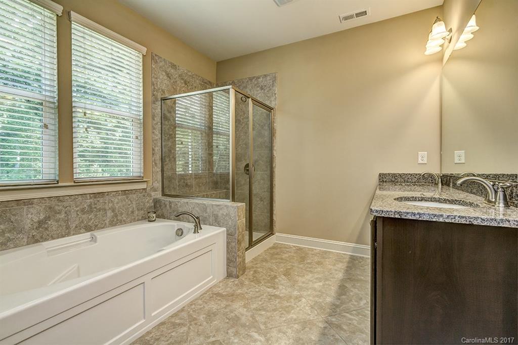3032 Fallondale Road Waxhaw, NC 28173 - Photo 17 of 23 a bathroom with a granite countertop sink and a bathtub