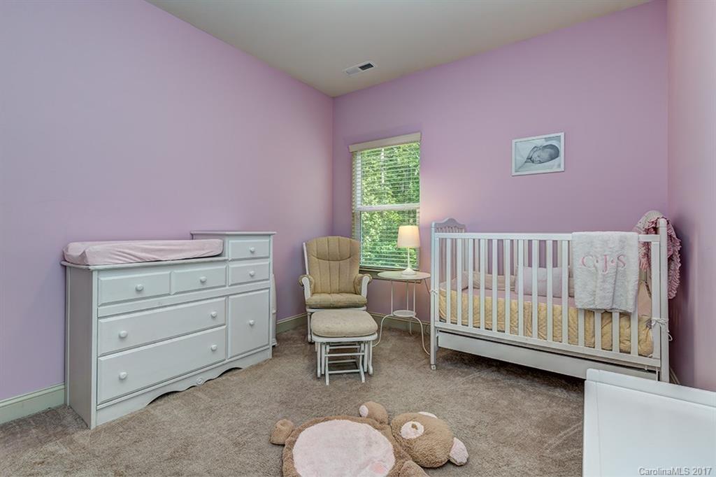 3032 Fallondale Road Waxhaw, NC 28173 - Photo 20 of 23 a bedroom with a baby bed a couch and chair