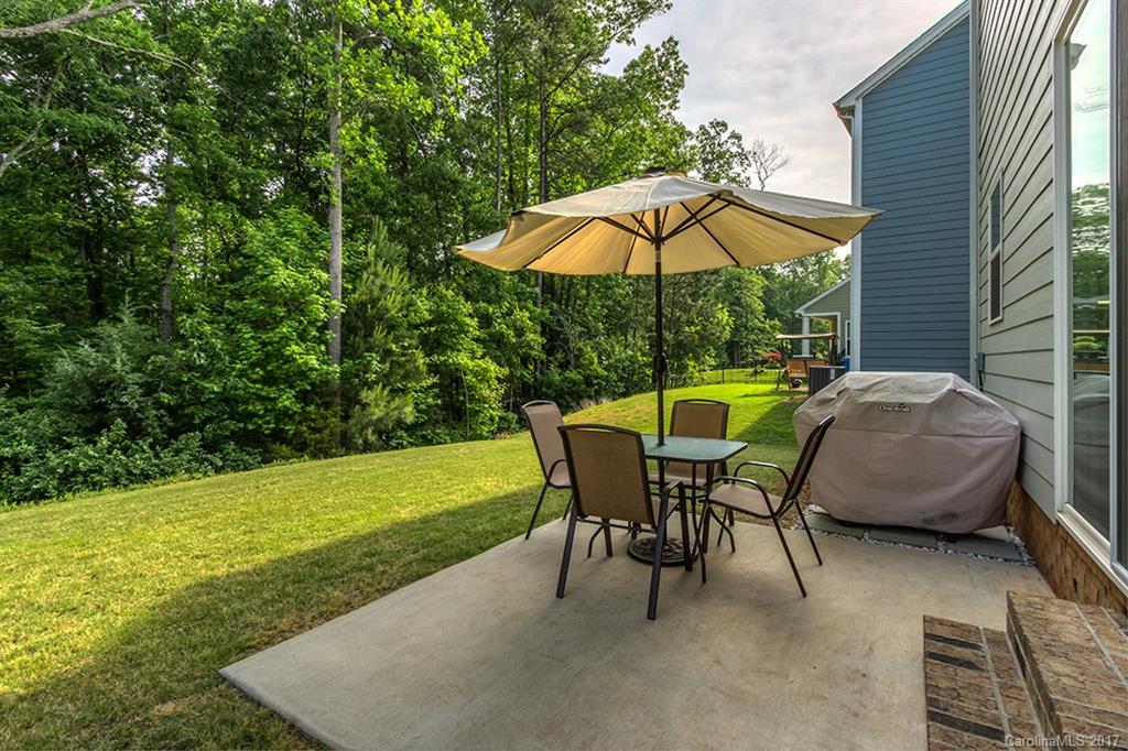 3032 Fallondale Road Waxhaw, NC 28173 - Photo 21 of 23 an outdoor sitting area with furniture and umbrella