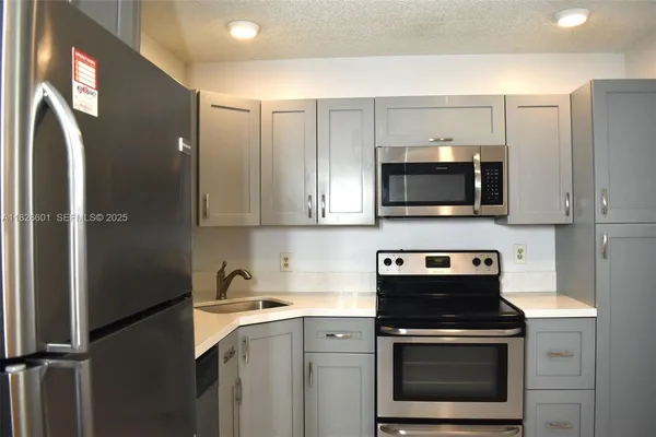a kitchen with stainless steel appliances a stove a microwave and cabinets