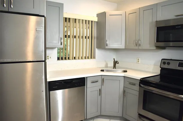 a kitchen with a sink and a refrigerator