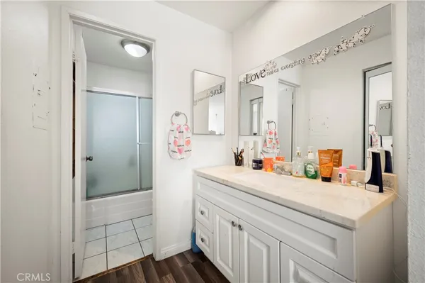 a bathroom with a sink vanity and a mirror
