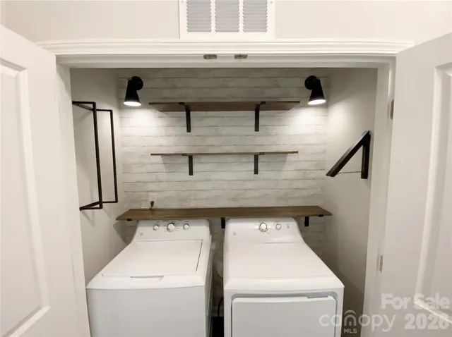 a view of storage and utility room with washer and dryer