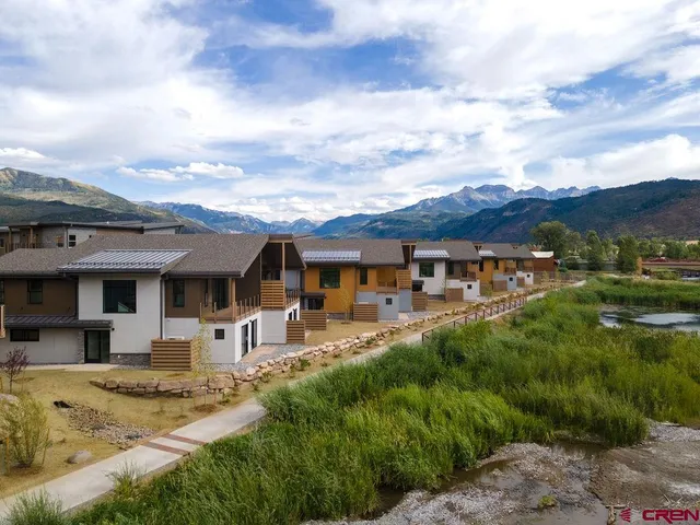 a front view of a house with a yard table and chairs