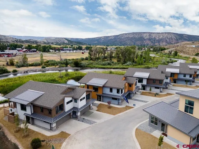 a street view with residential house and car parked