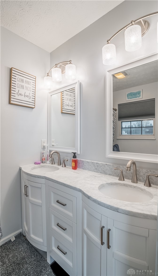 1442 Langdon Road Sidney, OH 45365 - Photo 18 of 34 This spacious bathroom features a double vanity with ample storage and elegant granite counters.