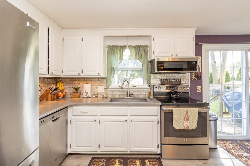 206 Pine Acre Road Springfield, MA 01129 - Photo 9 of 25 a kitchen with stainless steel appliances granite countertop a stove a sink and a refrigerator
