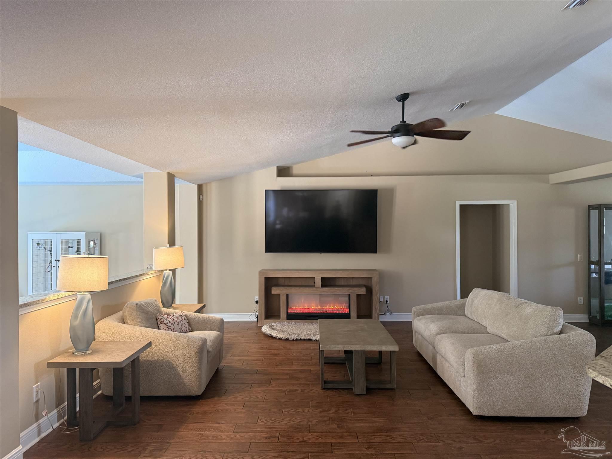 3055 Wallace Lake Road Pace, FL 32571 - Photo 22 of 33 a living room with furniture and a flat screen tv