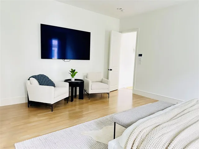 a bedroom with a bed and a mirror