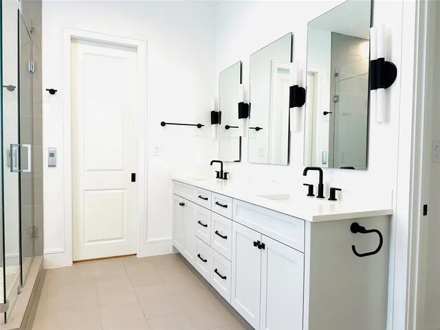 a bathroom with a tub a sink and shower