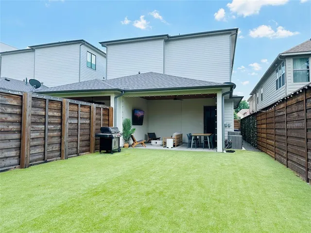 a view of a yard with wooden fence