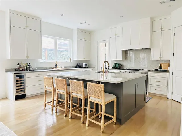 a kitchen with white cabinets sink and white appliances