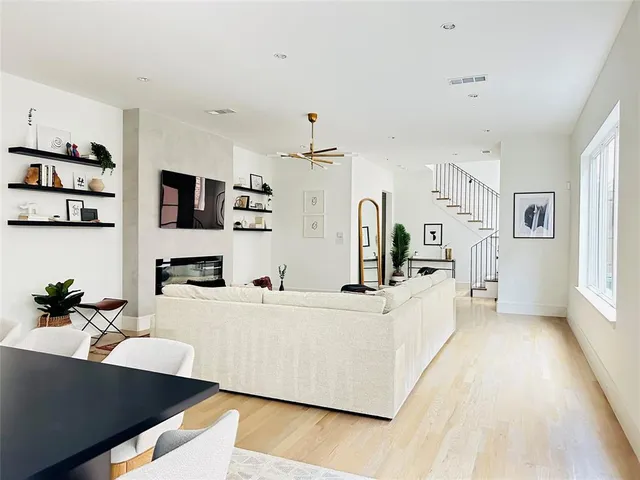 a kitchen with stainless steel appliances kitchen island granite countertop a table chairs sink and cabinets