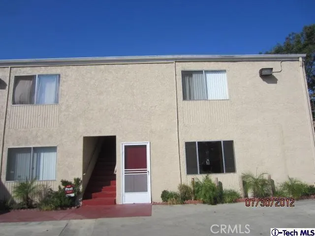 a front view of a house with plants