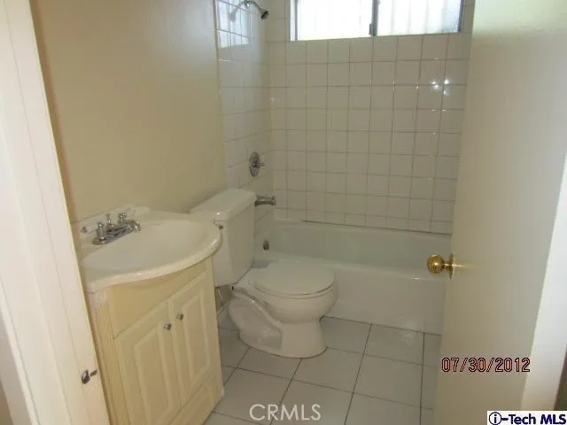 a bathroom with a toilet sink and shower