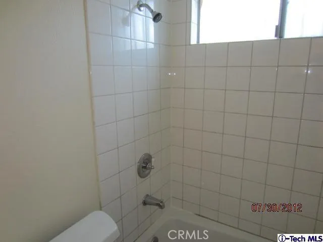 a bathroom with a toilet and shower