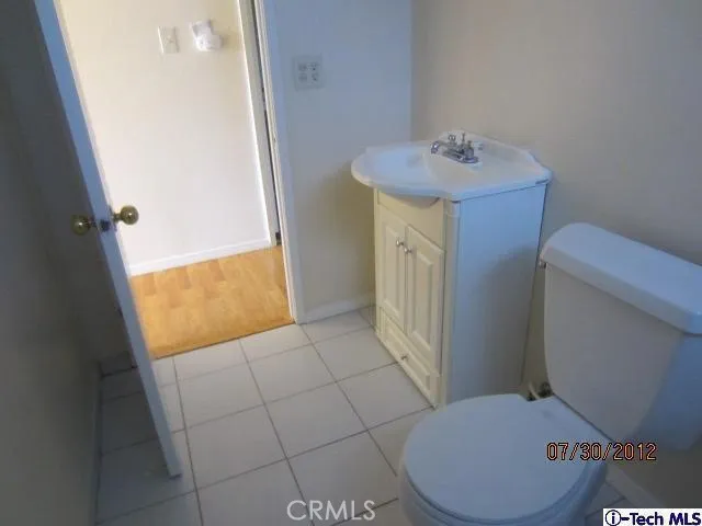 a bathroom with a sink a toilet and shower curtain