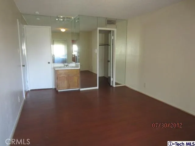 a view of a kitchen with a sink and a refrigerator